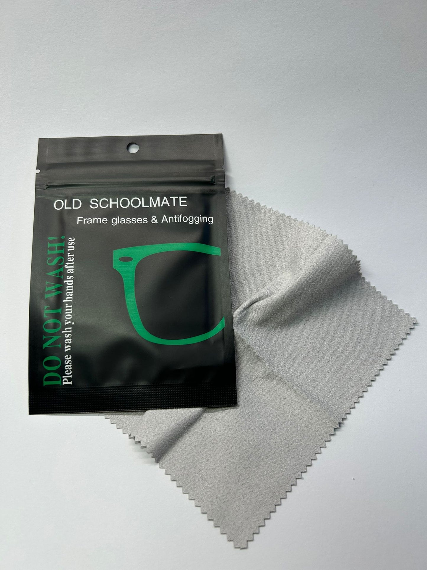 Old Schoolmate frame glasses and antifogging kit with a black pouch and gray cloth on a light gray background